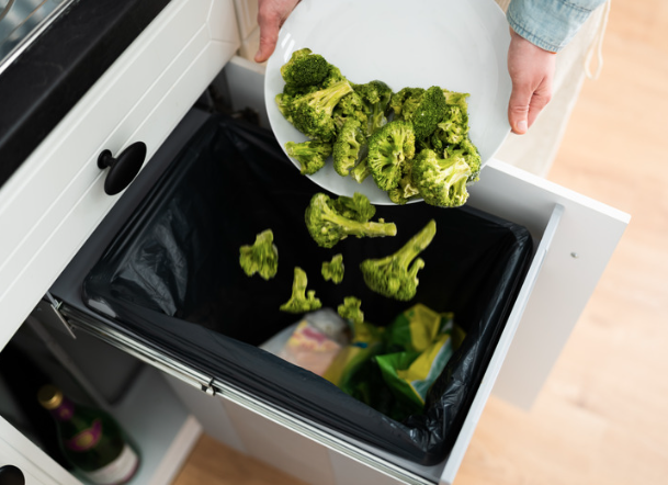 Child rejecting broccoli while parent reacts by removing it.